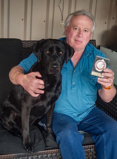 Neil with Evie and his award